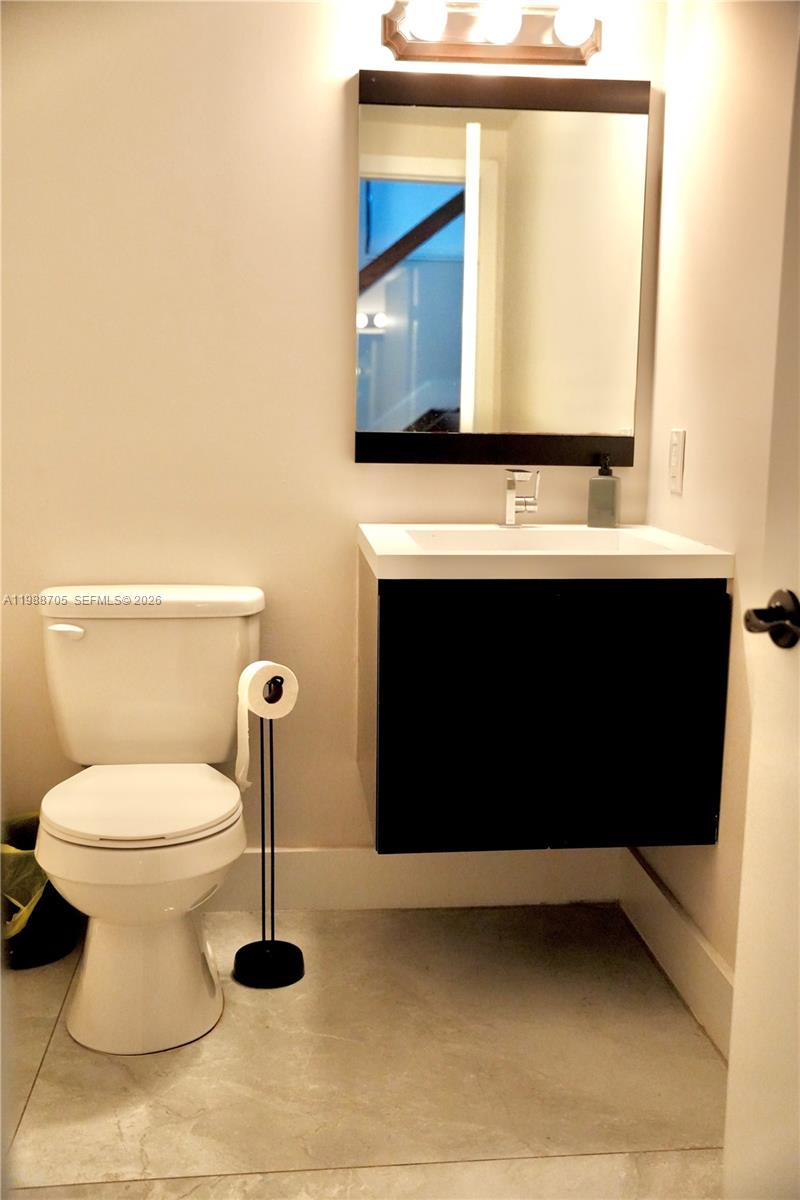 19262 Northwest 89th Avenue Hialeah, FL 33018 - Photo 9 of 20 a bathroom with a sink and a toilet
