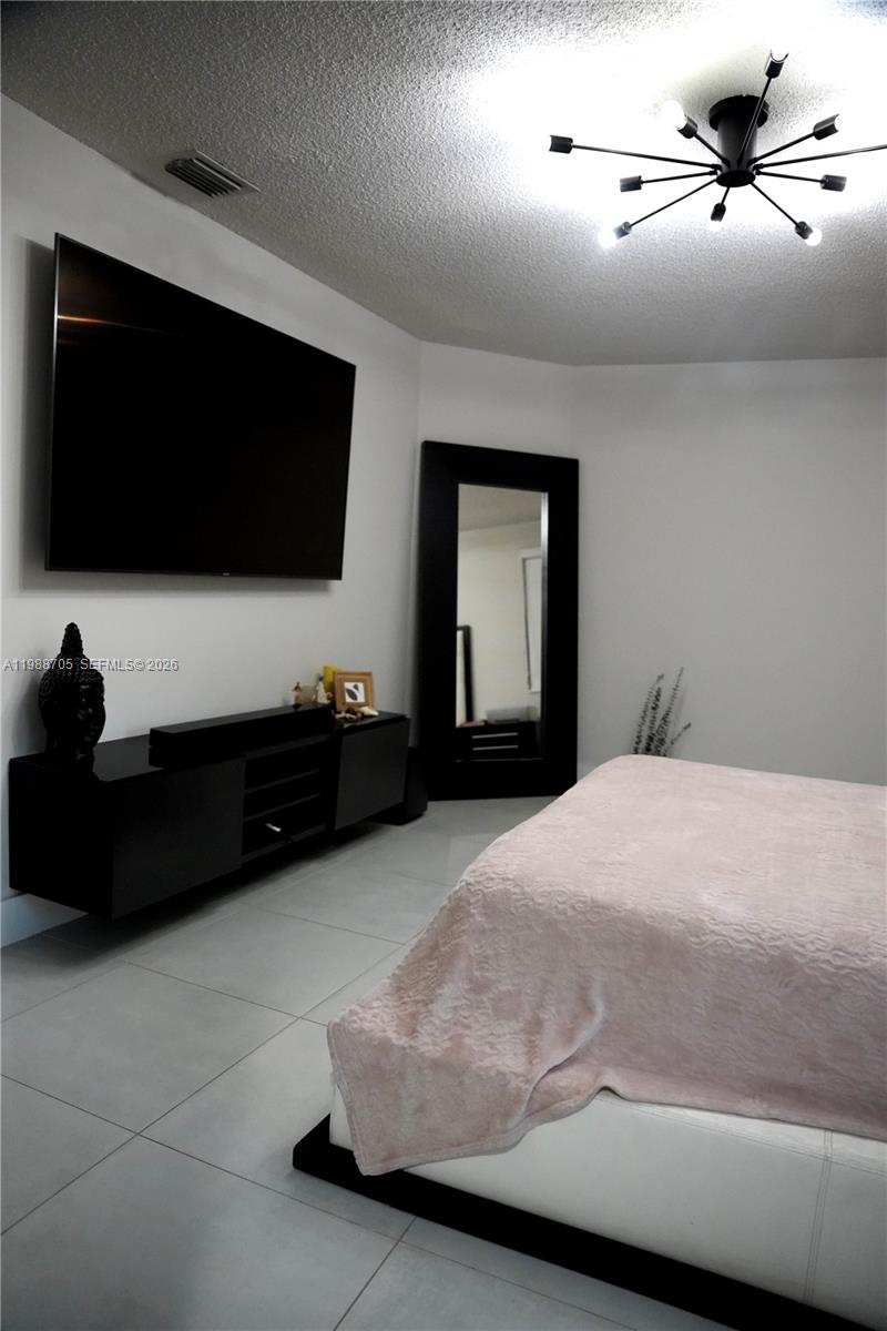 19262 Northwest 89th Avenue Hialeah, FL 33018 - Photo 10 of 20 a living room with a flat screen tv