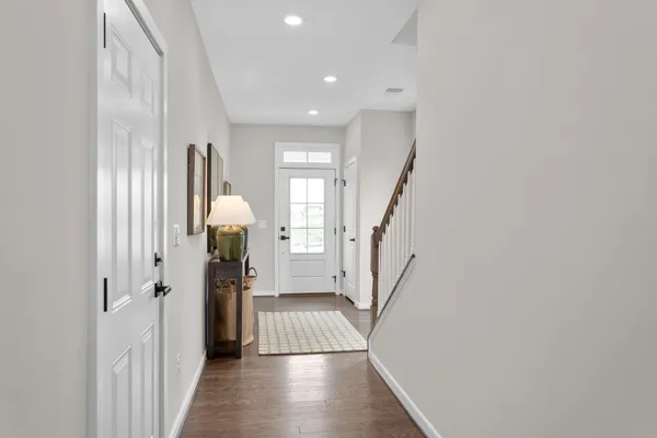 a view of a hallway with furniture and stairs