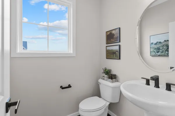 a white toilet sitting next to a bathroom sink