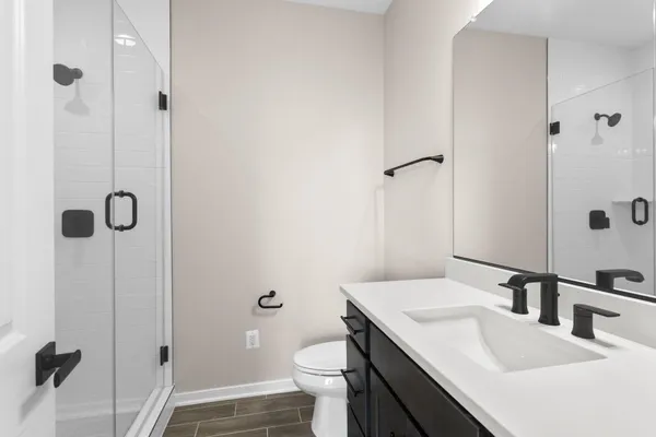 a bathroom with a sink toilet and shower