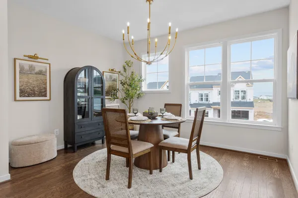 a view of a dining room with furniture window and wooden floor