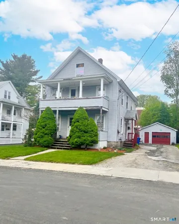 a front view of house with yard and green space
