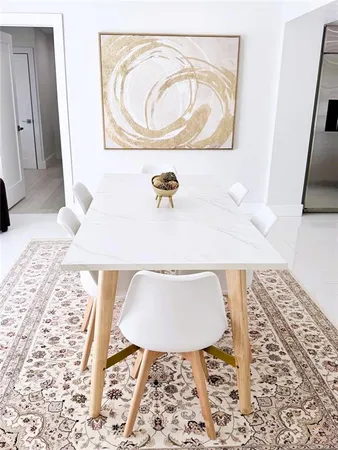 a kitchen with white cabinets and appliances