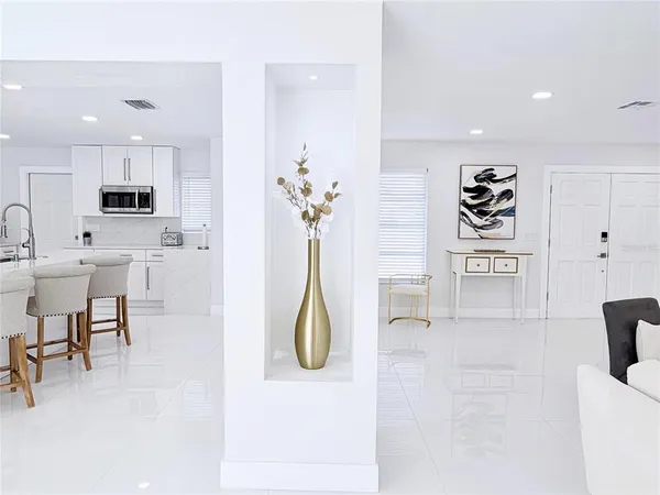 a large bedroom with a bed and a flat screen tv