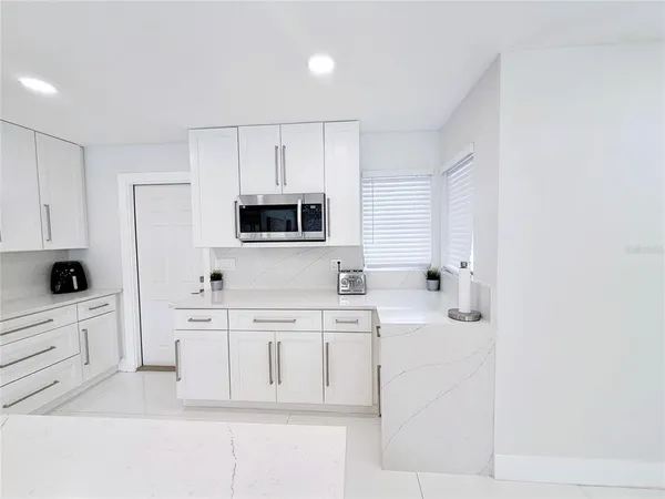 a bathroom with a sink a toilet a mirror and shower