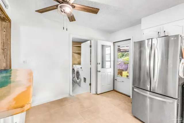 a view of a kitchen with refrigerator and cabinet