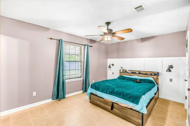 a living room with a bed and a chandelier