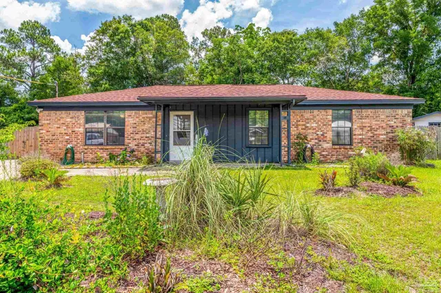 a view of a house with pool and garden