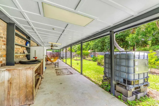 a view of a porch with wooden floor and iron stairs