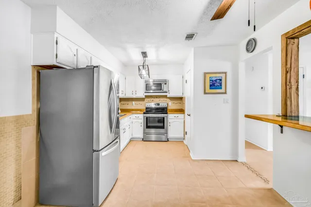 a kitchen with stainless steel appliances a refrigerator and a stove