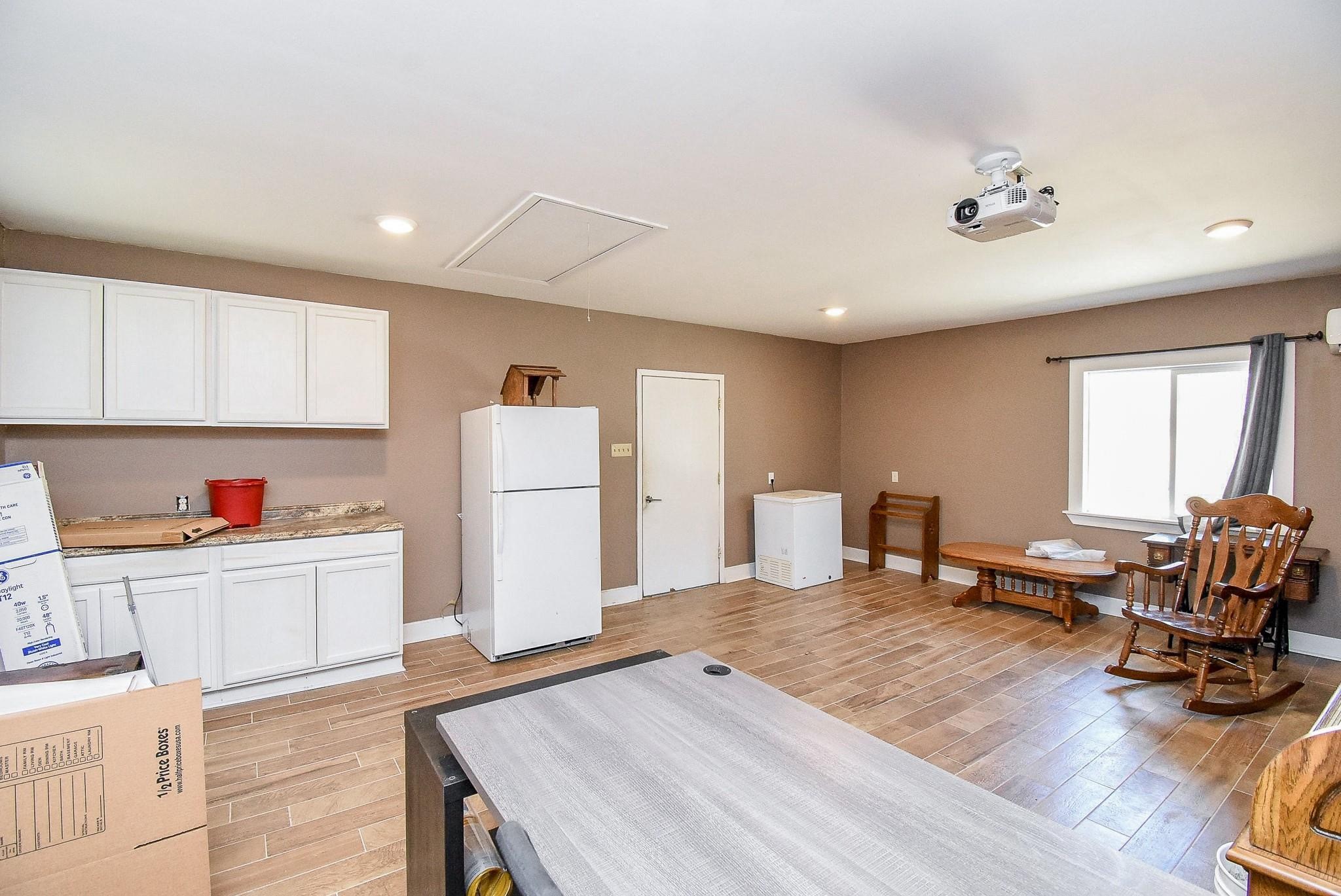 2719 Vail Road Rosenberg, TX 77471 - Photo 29 of 36 a living room with furniture and a refrigerator