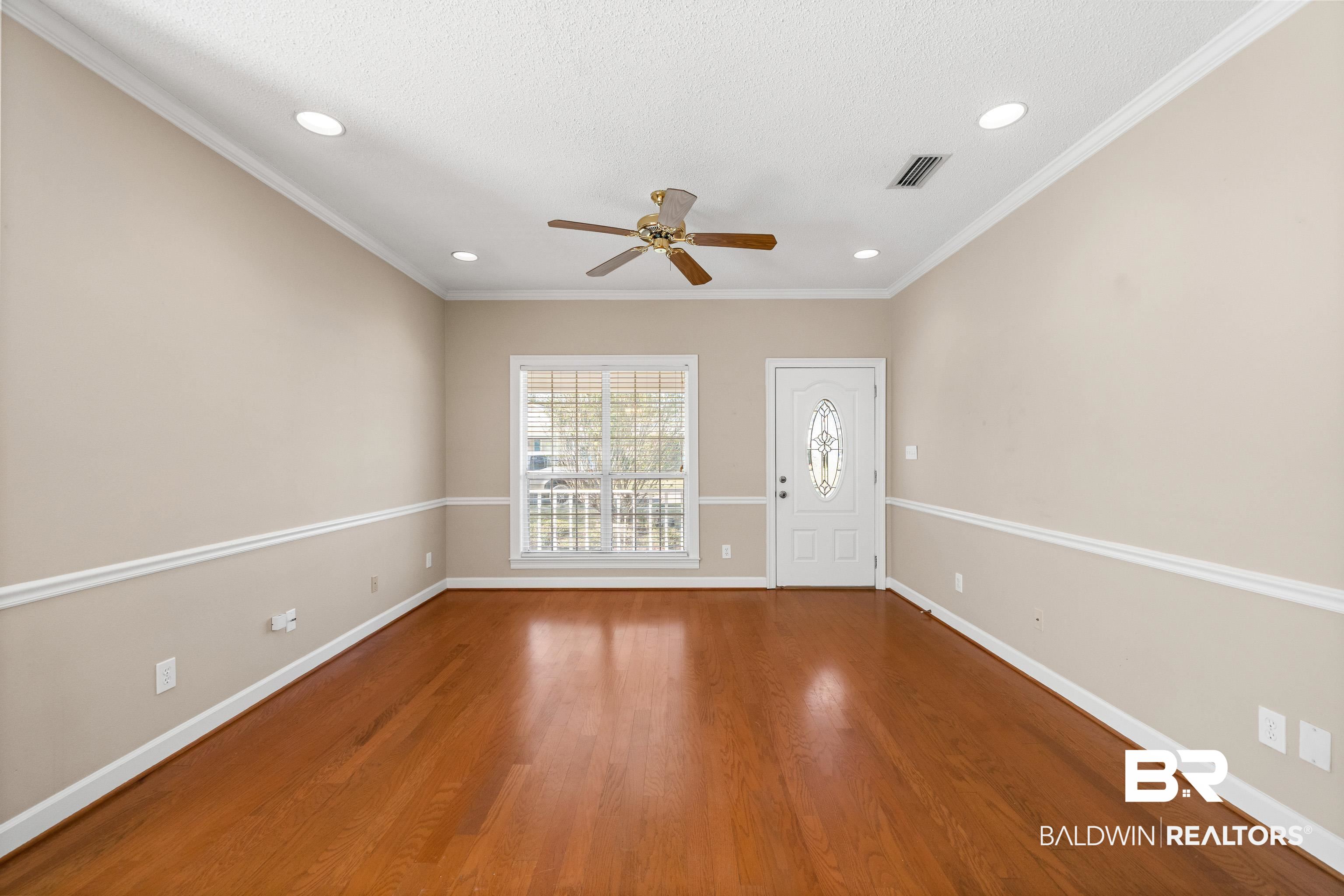 27 Cottage Drive Fairhope, AL 36532 - Photo 7 of 33 Empty room with ornamental molding, wood finished floors, recessed lighting, ceiling fan, and a textured ceiling