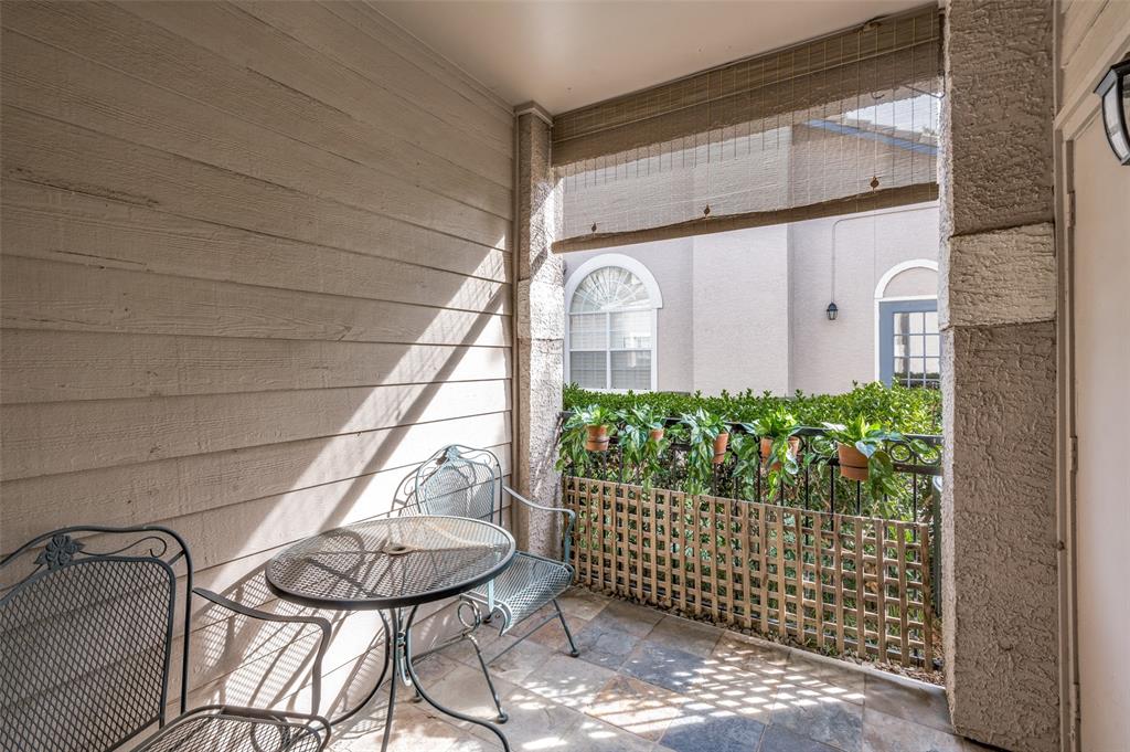2601 Preston Road, Unit 3103 Plano, TX 75093 - Photo 24 of 30 Back terrace secluded by manicured landscaping and a wrought iron fence. Storage room in terrace.