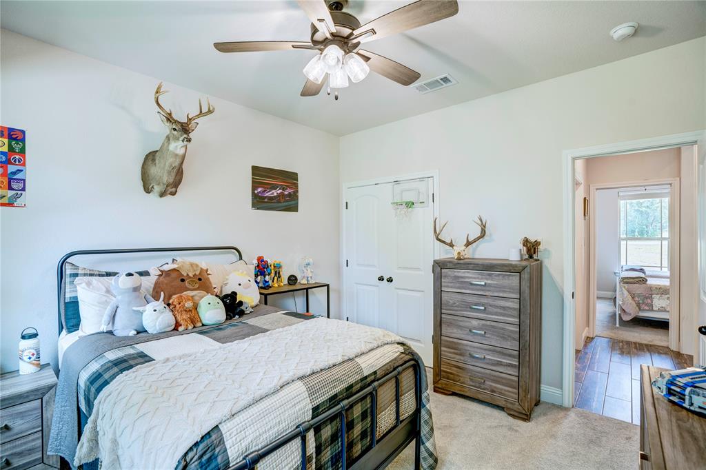 1355 Jay Bird Road Springtown, TX 76082 - Photo 35 of 40 a bedroom with a bed and wooden floor