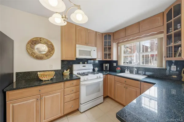 a kitchen with a sink cabinets and window