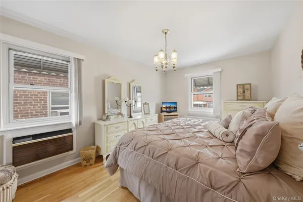 a spacious bedroom with a bed and a chandelier