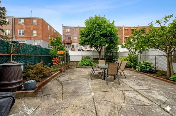 a view of a chairs and tables in the back yard of the house
