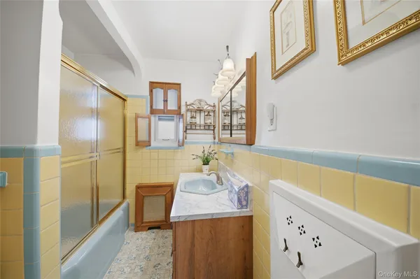 a bathroom with a tub sink and mirror