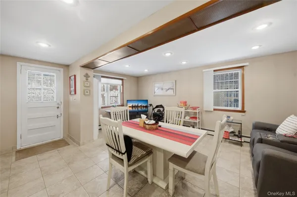 a living room with furniture a flat screen tv and a window