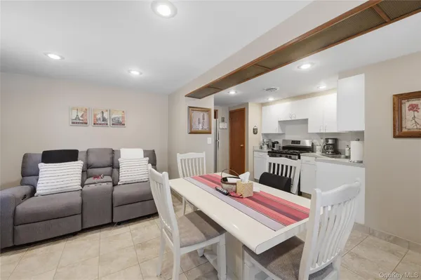 a bedroom with furniture and a view of kitchen