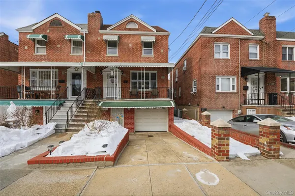 a view of a brick house with many windows and a table