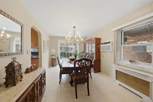 a view of a dining room with furniture and a chandelier