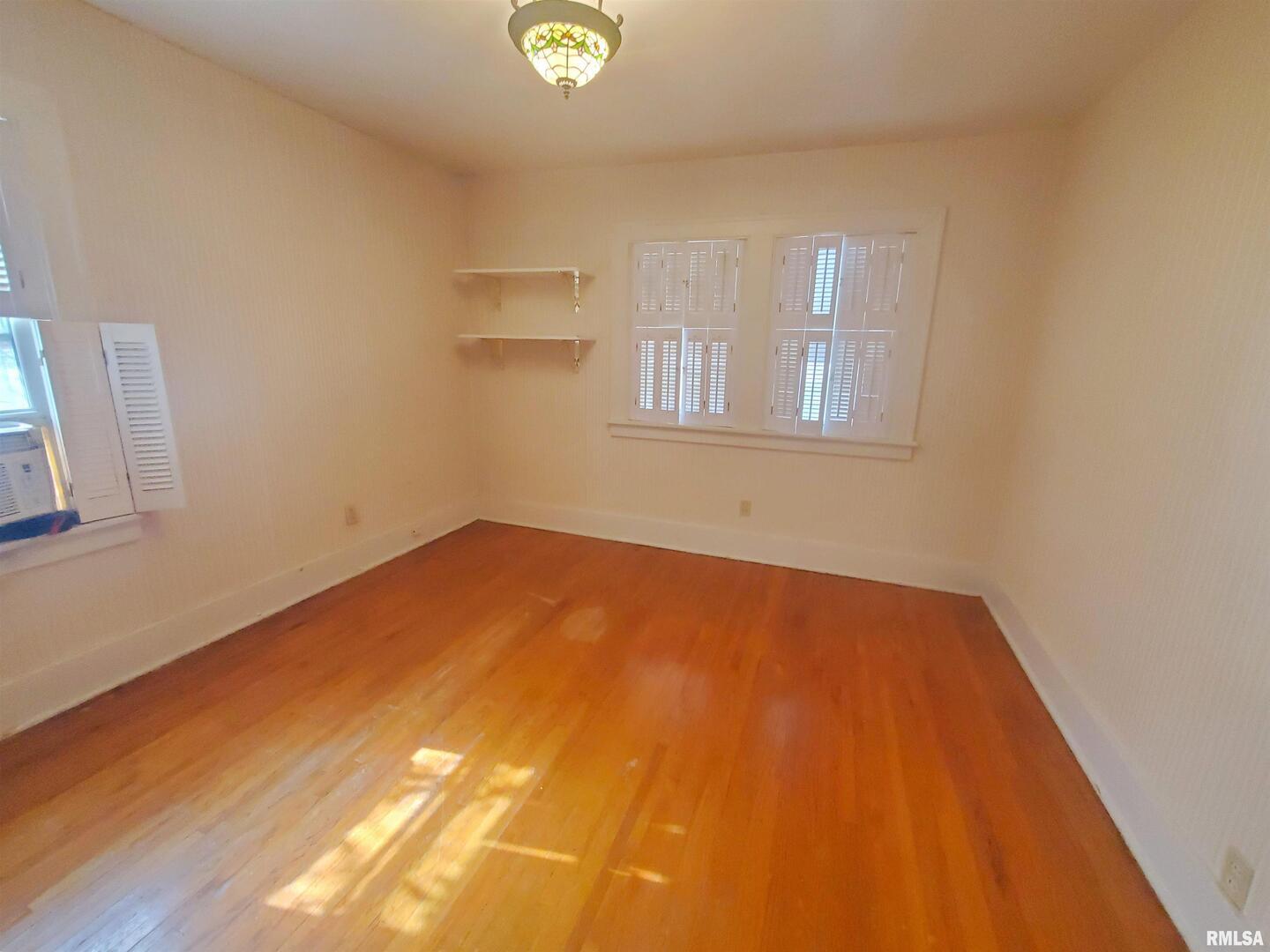1182 25th Street Moline, IL 61265 - Photo 14 of 17 a view of empty room with wooden floor