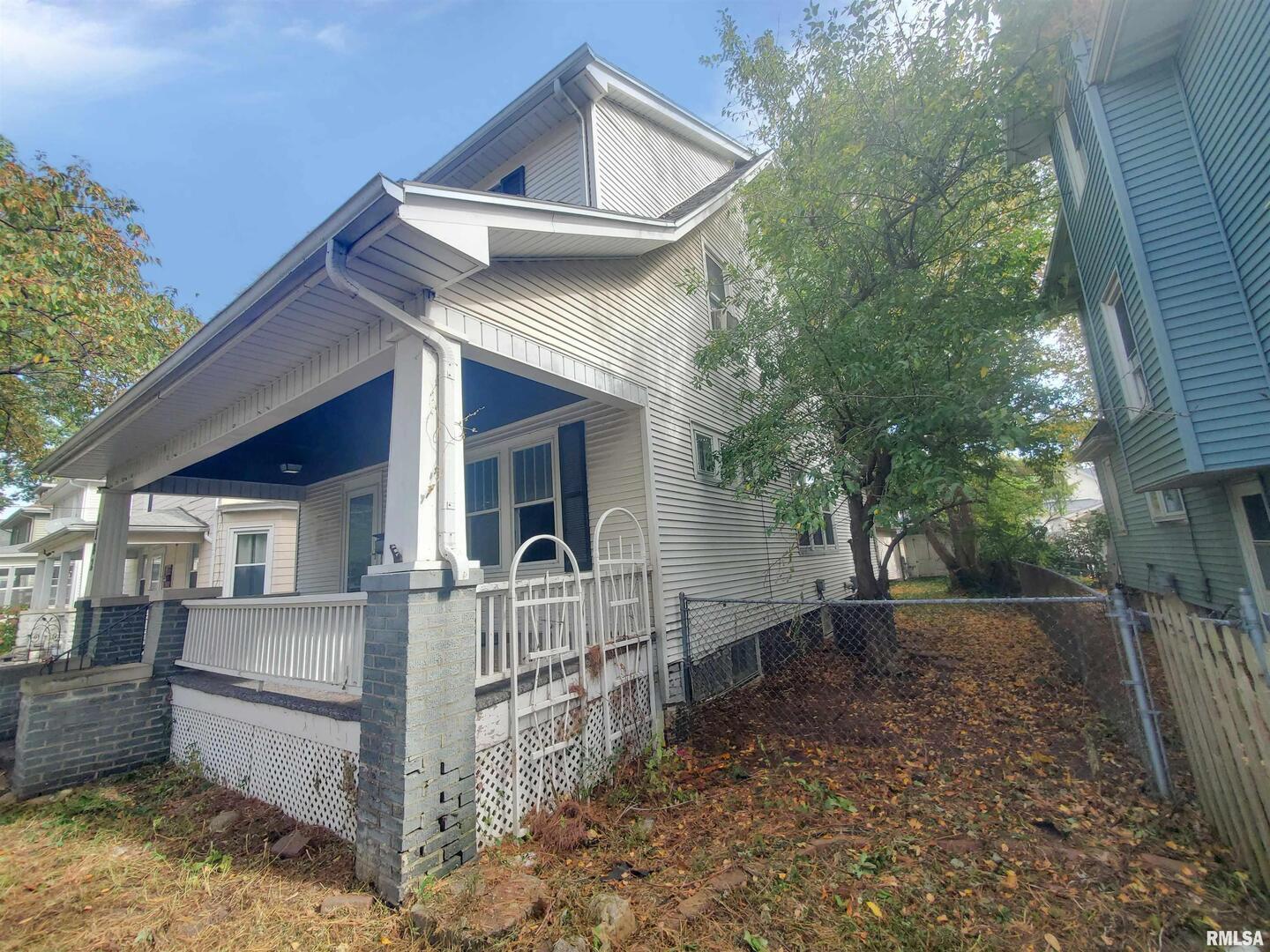 1182 25th Street Moline, IL 61265 - Photo 3 of 17 a view of a house with a yard and large tree