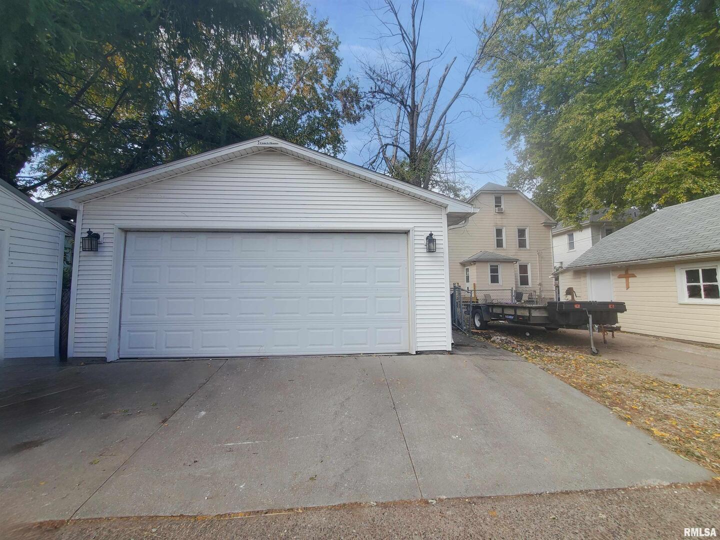 1182 25th Street Moline, IL 61265 - Photo 7 of 17 a view of a house with a yard and garage
