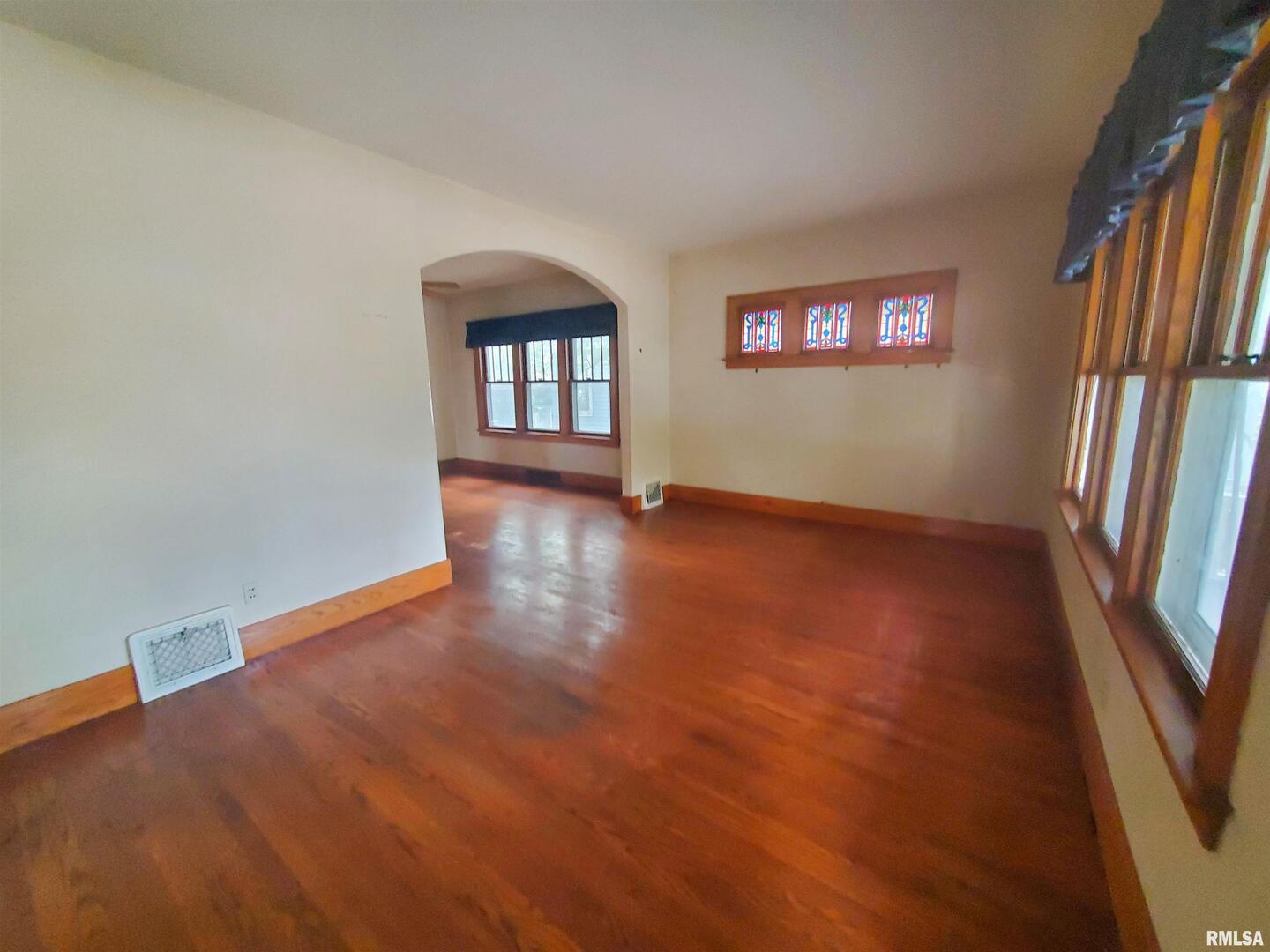 1182 25th Street Moline, IL 61265 - Photo 8 of 17 a view of an empty room with a window and wooden floor