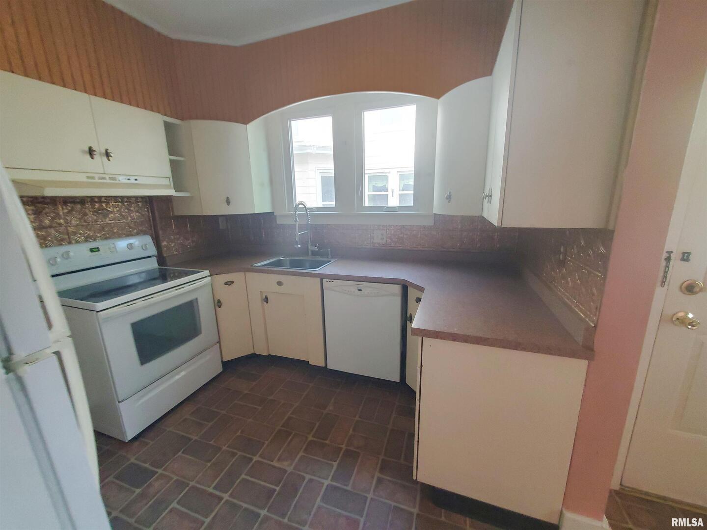 1182 25th Street Moline, IL 61265 - Photo 10 of 17 a kitchen with a white cabinets and white appliances