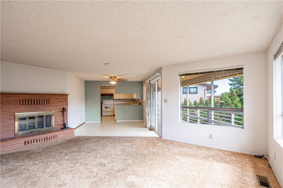 755 Wapato Way Manson, WA 98831 - Photo 12 of 40 a view of a livingroom with a fireplace and window