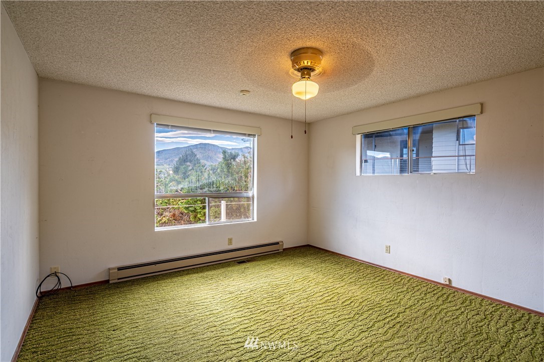 755 Wapato Way Manson, WA 98831 - Photo 16 of 40 a view of an empty room with a window