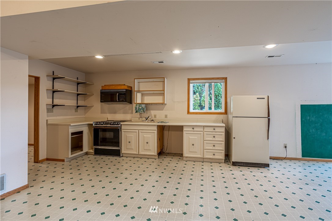 755 Wapato Way Manson, WA 98831 - Photo 32 of 40 a kitchen with a refrigerator and a stove