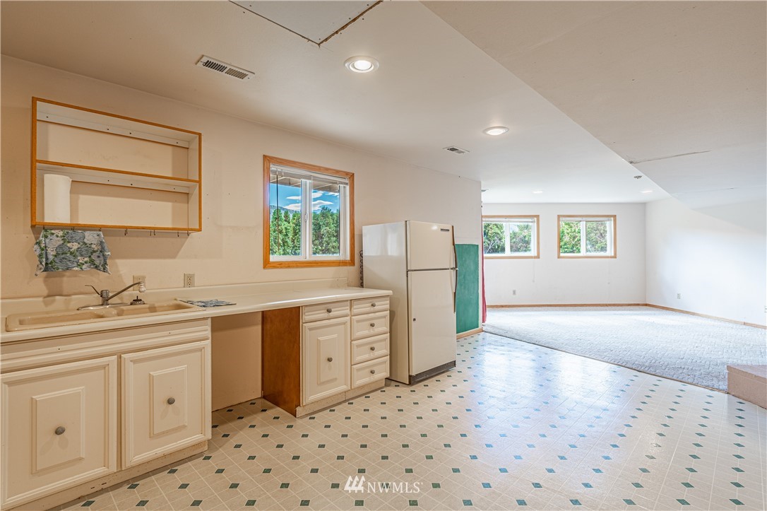 755 Wapato Way Manson, WA 98831 - Photo 33 of 40 a large bathroom with a sink a large mirror and a shower