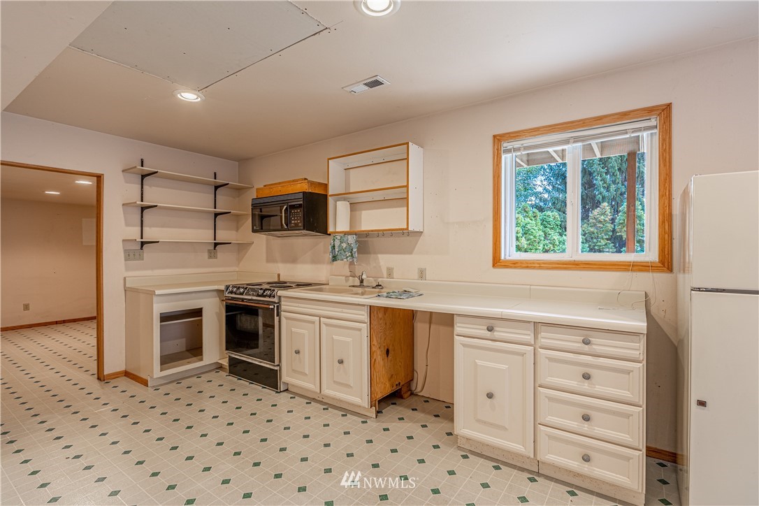 755 Wapato Way Manson, WA 98831 - Photo 34 of 40 a kitchen with granite countertop appliances cabinets and a sink
