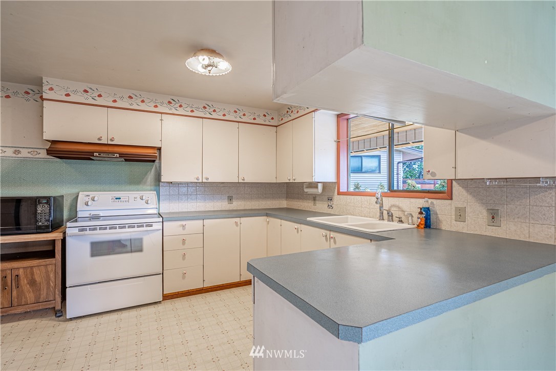 755 Wapato Way Manson, WA 98831 - Photo 6 of 40 a kitchen with a sink cabinets and window
