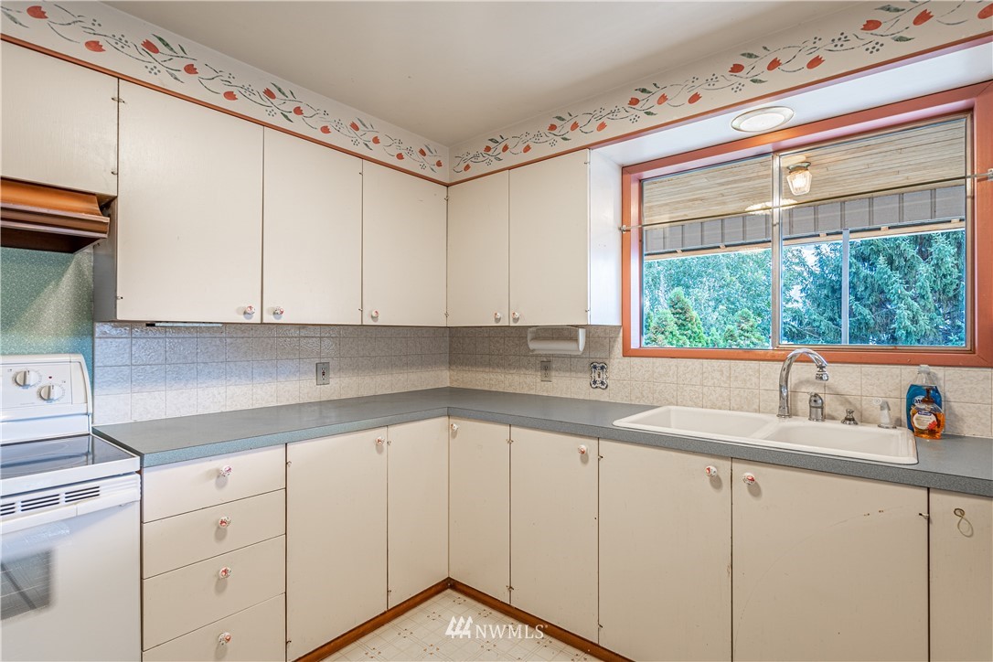 755 Wapato Way Manson, WA 98831 - Photo 8 of 40 a kitchen with a sink cabinets and window