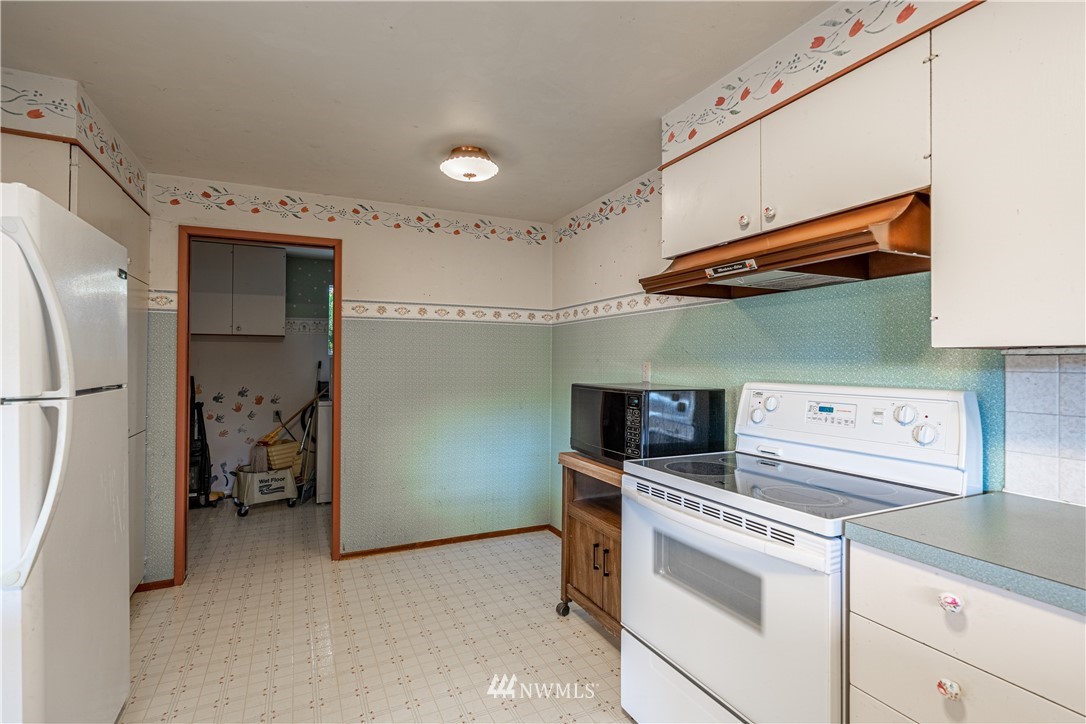 755 Wapato Way Manson, WA 98831 - Photo 9 of 40 a kitchen with a stove and a refrigerator
