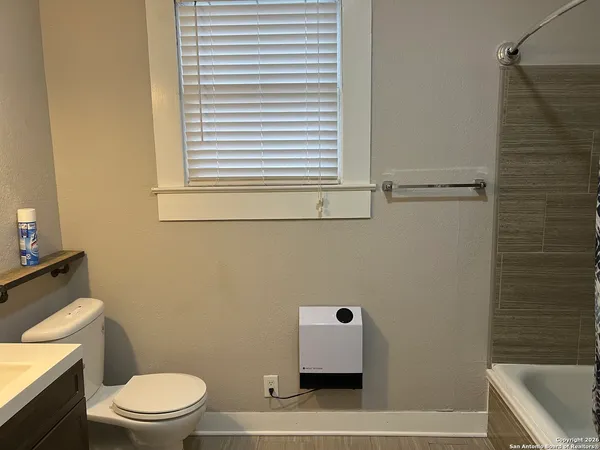 a bathroom with a toilet a sink and a bathtub