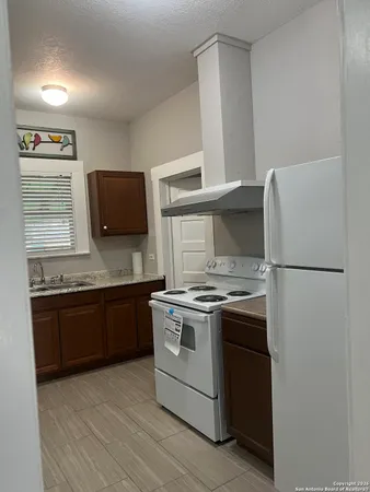 a kitchen with stainless steel appliances granite countertop a stove a refrigerator and a granite counter tops