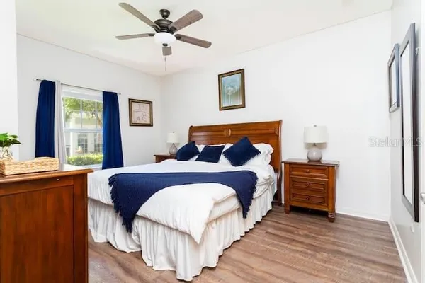 a bedroom with a bed and a chandelier