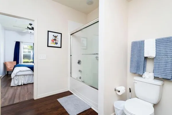 a bathroom with a toilet tub and shower