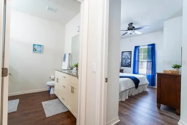 a spacious bedroom with a bed and a view of bathroom
