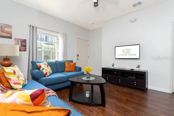 a living room with furniture and wooden floor
