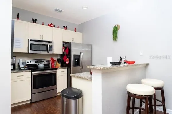 a kitchen with a sink cabinets and appliances