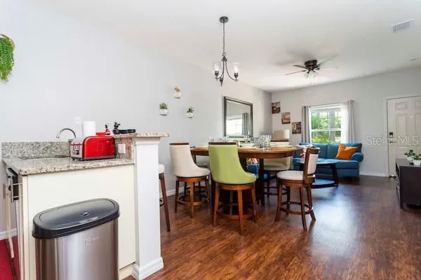 a view of a dining room with furniture and wooden floor