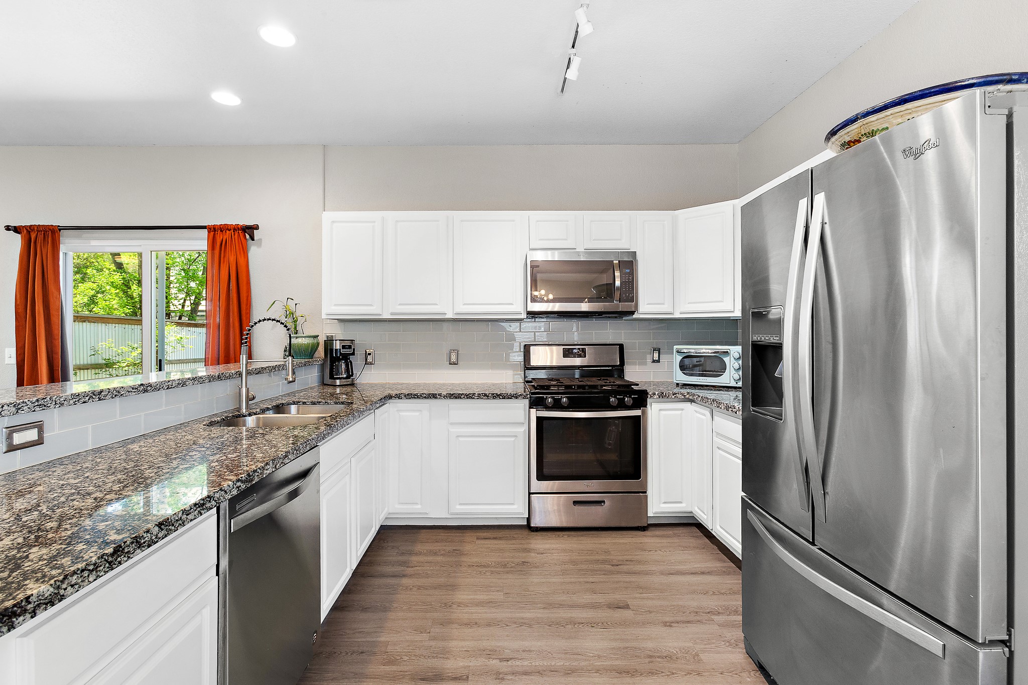 914 Bret Lane Austin, TX 78721 - Photo 13 of 34 a kitchen with stainless steel appliances a refrigerator sink and microwave