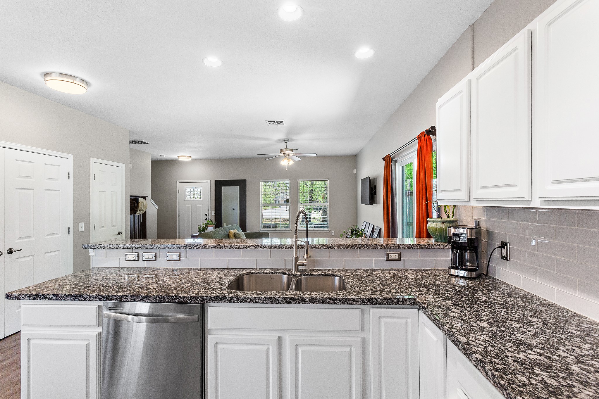 914 Bret Lane Austin, TX 78721 - Photo 14 of 34 a bathroom with a granite countertop sink and a large mirror
